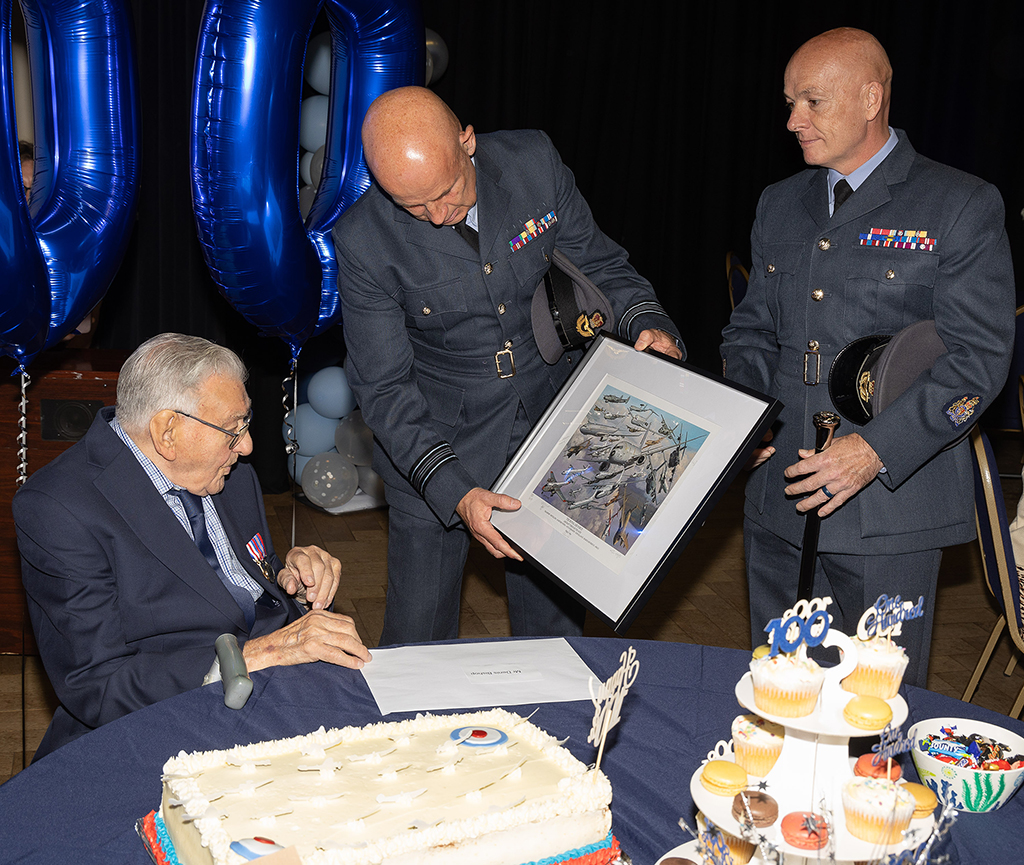 Personnel from RAF Brize Norton delivered to Denis, a card from the Station Commander and Commander Air Wing, a signed limited edition print entitled, 'Royal Air Force Aircraft Through the Ages' and a superbly decorated cake, baked by RAF Chef Corporal Bowers.
